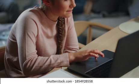 Portrait Of Smart Schoolgirl Learning Online With Computer Indoors. Closeup Cute Child Surfing Internet On Netbook At Home. Teenage Girl Looking Laptop Screen In Living Room With Family.