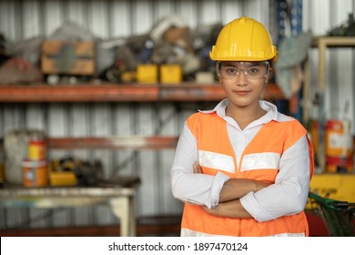 Portrait of smart women worker Asian race with protective safety suit standing smile - Powered by Shutterstock