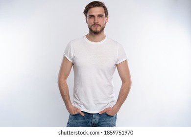 Portrait of a smart young man standing against white background. - Shutterstock ID 1859751970