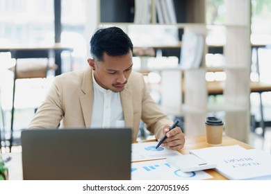 Portrait of sme business owner, man using computer and financial statements Anxious expression on expanding the market to increase the ability to invest in business. - Shutterstock ID 2207051965