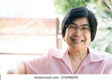 Portrait Of Smile Asian Elderly Mother. Asia Face Adult Older People With Happy Expression Wear Pink Shirt.
