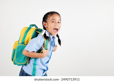 Portrait smile Asian little girl kindergarten holding a green and yellow backpack posing studio isolated white background, happy cute woman kid wear school uniform plaid skirt, back to school concept - Powered by Shutterstock