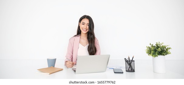 Portrait Smile Beautiful Business Asian Woman In Pink Suit Working In Office Desk Virtual Computer. Small Business Owner People Employee Freelance Online Sme Marketing E-commerce Telemarketing Concept