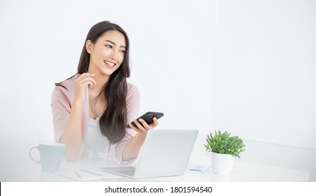 Portrait smile beautiful business asian designer woman with pink suit working office desk using phone computer. Small business employee freelance online sme marketing e-commerce telemarketing concept