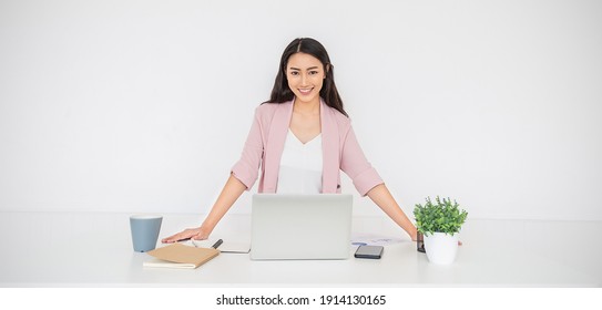 Portrait smile beautiful business asian creative woman pink suit working office desk virtual computer. Small business people employee freelance online sme marketing start up e-commerce, woman on top 