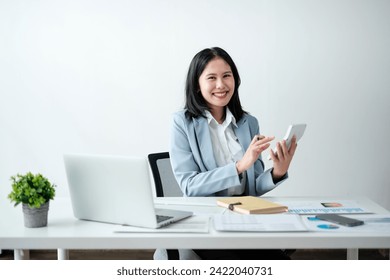 Portrait of smile beautiful business asian woman in blue suit working office desk computer. Small business sme .