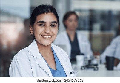 Portrait, smile and female doctor at work, healthcare and medical professional. Happy, hospital and Indian surgeon or wellness, clinic and medicare in scrubs, career and life insurance or physician - Powered by Shutterstock