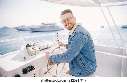 Portrait Smile Happy Man Driver Captain Of White Luxury Yacht Holding Helm Wheel, Summer Travel On Boat Sea.