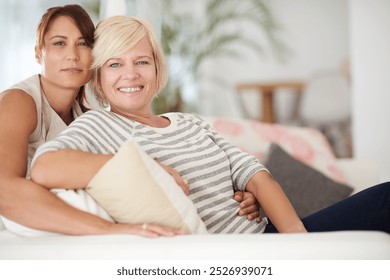 Portrait, smile and lesbian couple relax in home together for love, support and care. Face, lgbtq and happy queer women on sofa for connection, loyalty or trust in healthy relationship in living room - Powered by Shutterstock