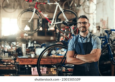 Portrait, smile and repair man in bicycle shop with arms crossed working in store. Face, bike mechanic and confident male person from Canada with happiness, glasses and mature in cycling workshop. - Powered by Shutterstock
