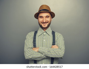 Portrait Of Smiley Hipster Man Over Grey Background