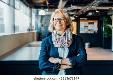 Portrait of smiling 50's stylish, confident mature businesswoman, middle aged company ceo director, experienced senior female professional, business coach team leader in modern office. Female leader. - Powered by Shutterstock