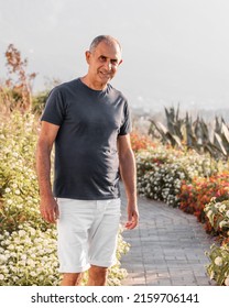 Portrait Of Smiling 60-years Old Man Standing Outside.