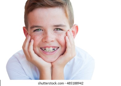 Portrait of a smiling 8 year old boy with green eyes and freckles 