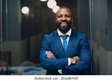 Portrait smiling african american businessman in blue suit in office. - Powered by Shutterstock