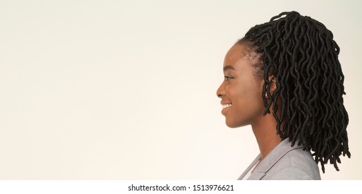 Portrait Of Smiling African American Businesswoman Looking Aside On White Background In Studio. Side View, Panorama, Empty Space