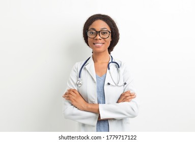 Portrait Of A Smiling African American Doctor Woman. Black Nurse In A White Coat.