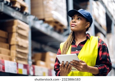 Portrait of smiling african american engineer woman order details checking goods and supplies on shelves with goods background in warehouse.logistic and business export - Powered by Shutterstock