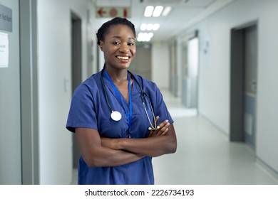 Portrait of smiling african american female doctor in hospital corridor, copy space. Hospital, medical and healthcare services. - Powered by Shutterstock