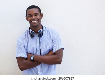 Portrait Of A Smiling African American Guy With Headphones Against White Background