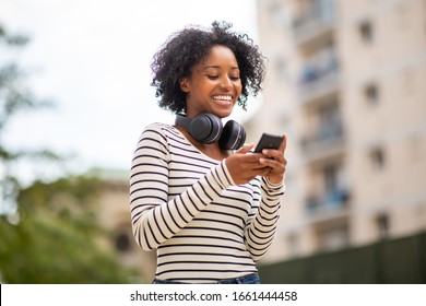 Portrait Smiling African American Woman Looking At Mobile Phone