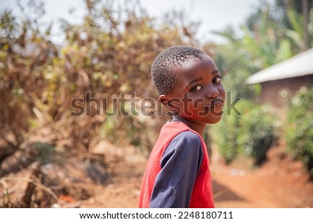 Portrait of a smiling African child in the village, photo with copy space