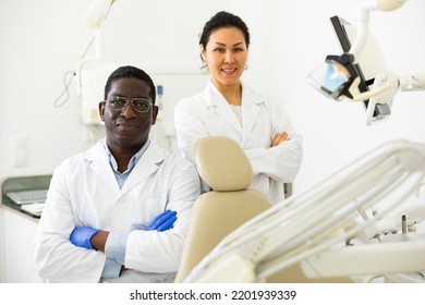 Portrait Of Smiling African-american Man And Asian Woman Dentist In Office Of Dental Clinic..