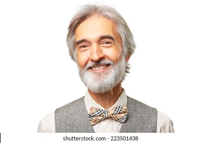 Portrait of smiling aged caucasian man with a gray beard and bowtie isolated on white background.