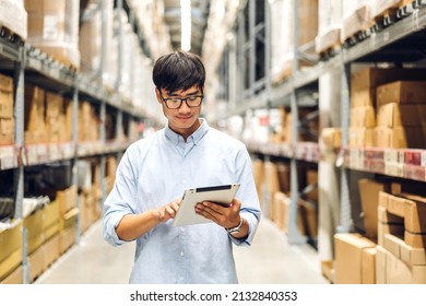 Portrait of smiling asian engineer foreman man order details checking goods on tablet and supplies on shelves with goods background in warehouse.logistic and business export - Shutterstock ID 2132840353