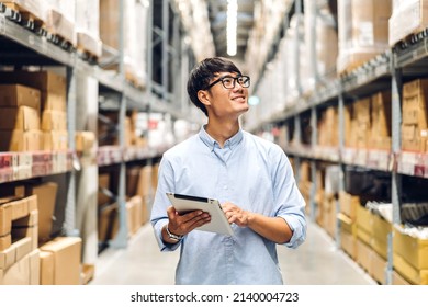 Portrait of smiling asian engineer foreman in helmets man order details checking goods and supplies on shelves with goods background in warehouse.logistic and business export - Shutterstock ID 2140004723