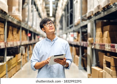 Portrait of smiling asian manager worker man standing and order details on tablet computer for checking goods and supplies on shelves with goods background in warehouse.logistic and business export