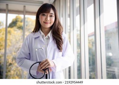 Portrait Of Smiling Asian Young Female Doctor Or Intern Medical Worker