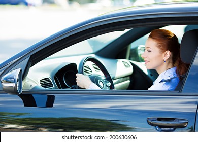 Portrait Smiling, Attractive Beautiful Brunette Woman Driving Black Car, Automobile, Checking Side Mirrors Before Making A Turn, Isolated Street, City Traffic Background. Safe Driving Habits Concept.