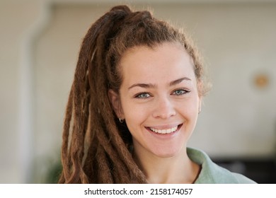 Portrait Of Smiling Attractive Girl With Dreads In Ponytail Posing In Modern Office