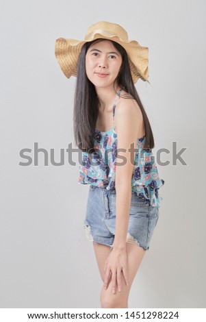 Portrait of a smiling attractive woman wearing hat  in summer on white background