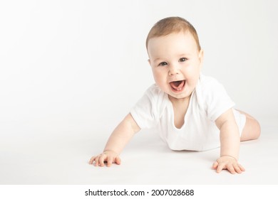 Portrait Of A Smiling Baby Lying On His Stomach