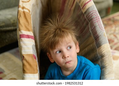 Portrait Of Smiling Baby With Standing Hair From Static Electricity