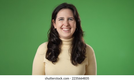 Portrait of smiling beautiful brunette blue eyes young woman 20s 30s years old posing isolated on green screen background studio. People sincere emotions lifestyle concept. - Powered by Shutterstock