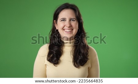 Portrait of smiling beautiful brunette blue eyes young woman 20s 30s years old posing isolated on green screen background studio. People sincere emotions lifestyle concept.