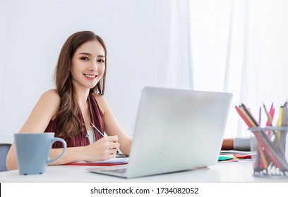 Portrait smiling beautiful business asian creative designer woman working in home office desk use computer. Small asia business people employee freelance online sme marketing e-commerce telemarketing 