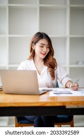 Portrait Of Smiling Beautiful Business Asian Woman With Working In Modern Office Desk Using Computer, Business People Employee Freelance Online Marketing E-commerce Telemarketing Concept.