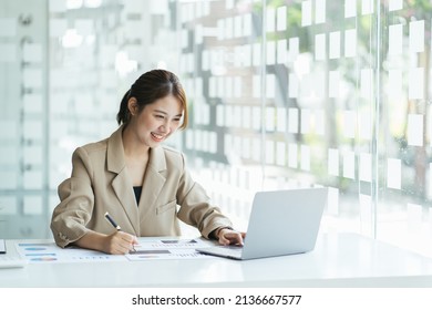 Portrait of smiling beautiful business asian woman working in office use computer with copy space. Business owner people sme freelance online marketing e-commerce telemarketing, work from home concept