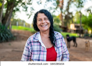 Portrait of smiling beautiful female farmer. Woman at farm in summer day. Gardening activity. Brazilian elderly woman. Latino people. - Powered by Shutterstock