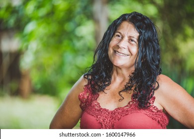 Portrait Of Smiling Beautiful Middle Age. Mature. Older Female Farmer. Woman At Farm In Summer Day. Gardening Activity. Brazilian Woman.