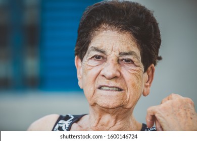 Portrait Of Smiling Beautiful Older Female Farmer. Woman At Farm In Summer Day. Gardening Activity. Brazilian Elderly Woman.