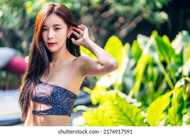 Portrait Of Smiling Beautiful Pretty Asian Woman Clean Fresh Healthy White Skin Posing.Girl Felling Relax And Enjoy Time In Swimming Pool On Summer Travel Vacation At Resort Spa.asia Beauty