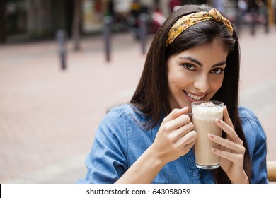 Portrait Of Smiling Beautiful Woman Drinking Cold Coffee