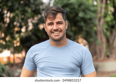 Portrait of smiling beautiful young male farmer. Man at farm in summer day. Gardening activity. Brazilian man. - Powered by Shutterstock