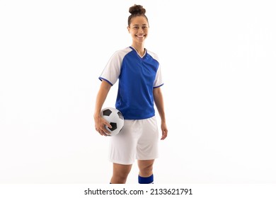 Portrait of smiling biracial young female soccer player with ball standing against white background. unaltered, sport, sports uniform, copy space, athlete and women's soccer. - Powered by Shutterstock