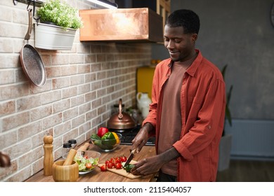 Portrait Of Smiling Black Man Cutting Vegetables While Cooking In Cozy Kitchen, Copy Space